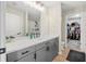 Modern bathroom with a double vanity, quartz countertop, and a beautifully tiled walk-in shower at 348 Southern Winds Blvd, Deland, FL 32720