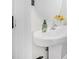 Bright bathroom featuring a pedestal sink, stylish faucet, and decorative accents at 348 Southern Winds Blvd, Deland, FL 32720