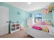 A well-lit bedroom featuring a white dresser and a charming bed, perfect for a cozy space at 348 Southern Winds Blvd, Deland, FL 32720
