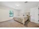 Bright bedroom featuring a cozy bed, a large window, and neutral decor for relaxation at 348 Southern Winds Blvd, Deland, FL 32720