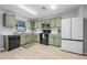 Well-equipped kitchen with green cabinetry, modern appliances, and a bright, airy ambiance at 348 Southern Winds Blvd, Deland, FL 32720