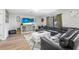 Inviting living room featuring a comfortable leather sectional and a large screen television at 348 Southern Winds Blvd, Deland, FL 32720