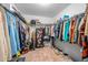 Spacious walk-in closet featuring wire shelving, ample hanging space, and carpeted flooring for organized storage at 348 Southern Winds Blvd, Deland, FL 32720