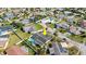 Aerial view of a home with a private backyard pool, manicured lawn, and a neighboring property at 4 Water Oak Cir, Ormond Beach, FL 32176