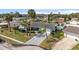 Aerial view of a home with a well-kept lawn, palm trees, and a spacious driveway in a quiet neighborhood at 4 Water Oak Cir, Ormond Beach, FL 32176