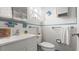 Clean bathroom features blue accents and a sink with adjacent toilet, all well lit by a window at 4 Water Oak Cir, Ormond Beach, FL 32176
