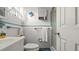 Clean bathroom featuring blue accents, vanity, toilet, and a shower behind a sliding glass door at 4 Water Oak Cir, Ormond Beach, FL 32176