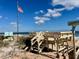 Aqua Vista community beach access with seating and ocean views under a partly cloudy sky at 4 Water Oak Cir, Ormond Beach, FL 32176