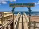 Aqua Vista Circles beach access sign with dolphin accents and wooden walkway to a sandy beach at 4 Water Oak Cir, Ormond Beach, FL 32176