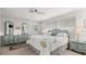 Bright bedroom features neutral walls, ceiling fan, and matching dressers on either side of a comfy king bed at 4 Water Oak Cir, Ormond Beach, FL 32176