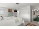 Bright bedroom features neutral walls, ceiling fan, and a sizable closet, offering ample storage space at 4 Water Oak Cir, Ormond Beach, FL 32176