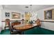 Formal dining room features beautiful wood table, chandelier, and decorative mirror at 4 Water Oak Cir, Ormond Beach, FL 32176