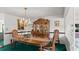 Formal dining room features a wooden table, a chandelier and a china cabinet at 4 Water Oak Cir, Ormond Beach, FL 32176