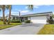 Charming single-story home with a well-manicured lawn and a spacious driveway, featuring an American flag at 4 Water Oak Cir, Ormond Beach, FL 32176