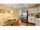 Eat-in kitchen features stainless steel appliances, ceiling fan, and charming breakfast table at 4 Water Oak Cir, Ormond Beach, FL 32176