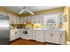 Functional kitchen with white cabinets, essential appliances, and bright lighting for cooking and meal preparation at 4 Water Oak Cir, Ormond Beach, FL 32176