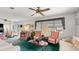 Living room features plush seating, a ceiling fan, and ample natural light from the windows at 4 Water Oak Cir, Ormond Beach, FL 32176