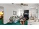 Relaxing living room features a fireplace, a ceiling fan and cozy floral couch at 4 Water Oak Cir, Ormond Beach, FL 32176