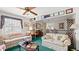 Cozy living room showcasing two floral sofas, a ceiling fan and decorative decor at 4 Water Oak Cir, Ormond Beach, FL 32176