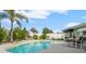 Backyard pool with lush landscaping and a pristine white fence at 4 Water Oak Cir, Ormond Beach, FL 32176