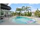 Inviting backyard pool featuring mature landscaping and lounge areas perfect for relaxing and entertaining at 4 Water Oak Cir, Ormond Beach, FL 32176