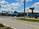Exterior view of Oceanside Beach Bar and Grill featuring outdoor seating and palm trees at 4 Water Oak Cir, Ormond Beach, FL 32176
