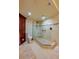 Neutral toned bathroom with glass walk in shower, built in bench and dark wood storage at 4555 S Atlantic Ave # 4508, Port Orange, FL 32127