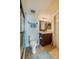 Well-lit bathroom features a glass-enclosed shower and vanity with dark wood cabinetry at 4555 S Atlantic Ave # 4508, Port Orange, FL 32127