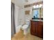 Traditional bathroom featuring a tub with shower, classic vanity, toilet, and patterned wallpaper at 4555 S Atlantic Ave # 4508, Port Orange, FL 32127