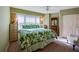 Inviting bedroom with green floral bedding, ceiling fan, and light filled windows at 4555 S Atlantic Ave # 4508, Port Orange, FL 32127