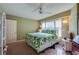 Bedroom featuring green palm frond bedding, ceiling fan and large, light-filled windows at 4555 S Atlantic Ave # 4508, Port Orange, FL 32127