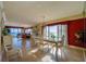 Dining room with chandelier, gulf views, red accents, and natural light at 4555 S Atlantic Ave # 4508, Port Orange, FL 32127