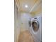 Convenient laundry area with a side-by-side washer and dryer unit, closet, and neutral walls at 4555 S Atlantic Ave # 4508, Port Orange, FL 32127