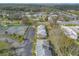 Aerial view of townhouse community featuring a tennis court, parking, and easy access to main roads at 1101 Deer Springs Rd, Port Orange, FL 32129