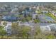 Aerial view of a townhouse community featuring a pond, tennis courts, and well-maintained landscaping at 1101 Deer Springs Rd, Port Orange, FL 32129