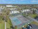 Aerial view of the townhouses, tennis courts, and street access in the community at 1101 Deer Springs Rd, Port Orange, FL 32129