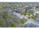 Scenic aerial view of townhouse community with lush landscaping, a pond, and mature trees at 1101 Deer Springs Rd, Port Orange, FL 32129