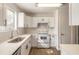 A bright kitchen featuring white cabinets and countertops with stainless steel appliances at 1101 Deer Springs Rd, Port Orange, FL 32129