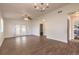 A spacious living room with wood floors, a ceiling fan, and natural light from french doors and windows at 1101 Deer Springs Rd, Port Orange, FL 32129