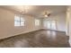 A spacious living room with wood floors, a ceiling fan, chandelier, and natural light at 1101 Deer Springs Rd, Port Orange, FL 32129