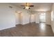 A spacious living room with wood floors, a ceiling fan, chandelier, and natural light at 1101 Deer Springs Rd, Port Orange, FL 32129