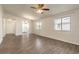 A spacious living room with wood floors, a ceiling fan, and natural light from windows at 1101 Deer Springs Rd, Port Orange, FL 32129