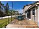 Relaxing back deck featuring an outdoor dining set, ideal for enjoying the outdoors at 13 Twin River Dr, Ormond Beach, FL 32174