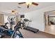 Bright exercise room features fitness equipment, sliding glass doors to the outside and ceiling fans at 13 Twin River Dr, Ormond Beach, FL 32174