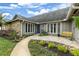 Inviting home entrance with stone walkway, manicured landscaping, and a bright blue door at 13 Twin River Dr, Ormond Beach, FL 32174