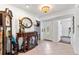 Bright foyer with tiled floors, decorative furniture, and a stained-glass front door at 13 Twin River Dr, Ormond Beach, FL 32174