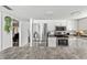 Bright kitchen with stainless steel appliances, white cabinets, ample counter space, and natural light from the doorway at 13 Twin River Dr, Ormond Beach, FL 32174