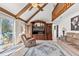 Living room featuring vaulted ceilings with exposed beams and access to an outdoor patio at 13 Twin River Dr, Ormond Beach, FL 32174