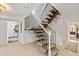 Bright foyer features carpeted stairs with elegant black and wood banisters leading to the upper level at 13 Twin River Dr, Ormond Beach, FL 32174