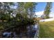 Scenic waterfront view with lush foliage, calm water, and wooden supports on a sunny day at 13 Twin River Dr, Ormond Beach, FL 32174